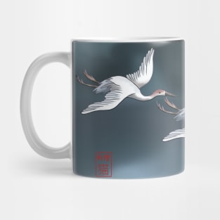 Two Japanese cranes flying over a dark lake Mug
